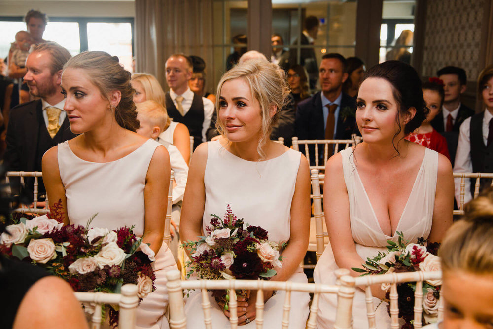 Copy of bridesmaids holding bouquets during wedding service