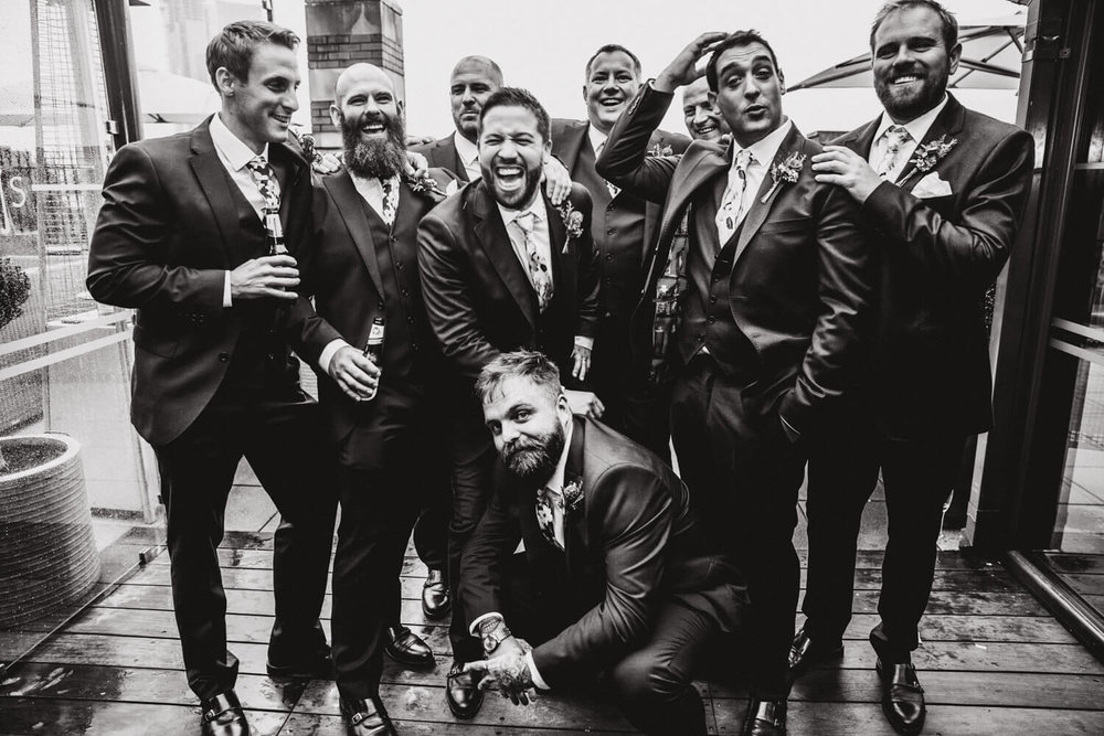 Copy of black and white photograph of groomsmen posing to camera at great john street hotel wedding
