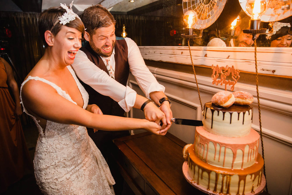 Copy of bride and groom cutting wedding cake at great john street hotel a