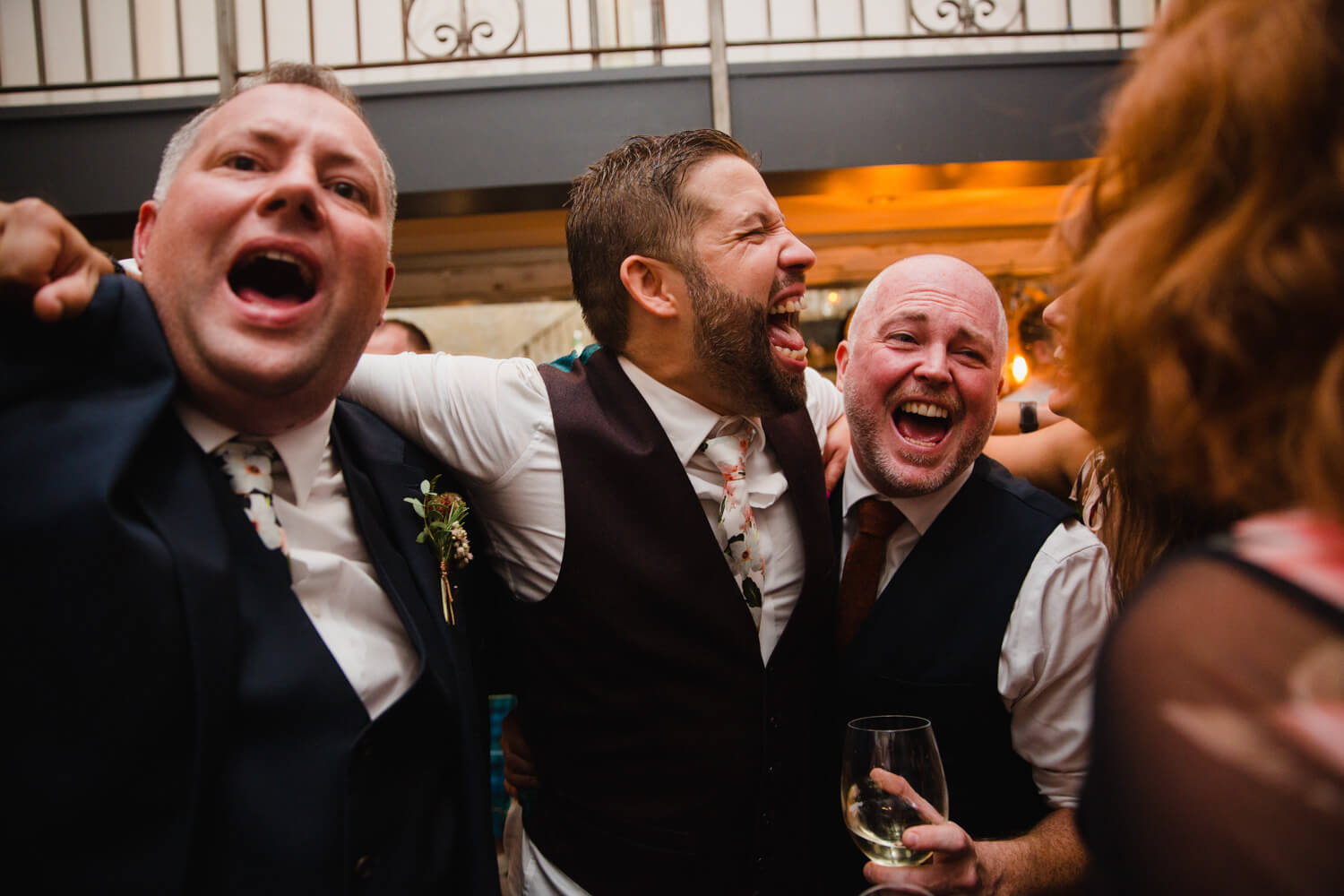 groom partying with groomsmen and friends at end of the night