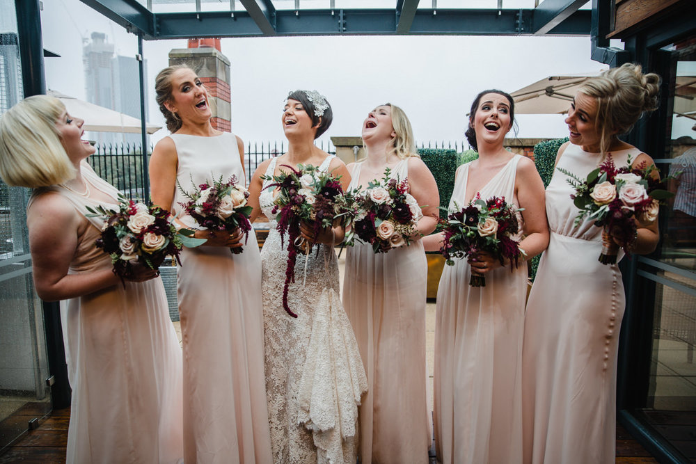 Copy of bridal party all laughing for group photograph at great john street hotel