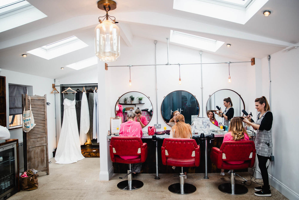 wide angle lens photograph inside owen house wedding barn bridal suite as bride tribe apply make-up