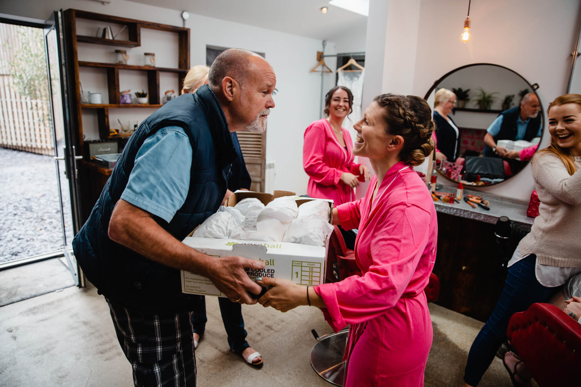 father of bridesmaid delivers sandwiches to bridal party before ceremony