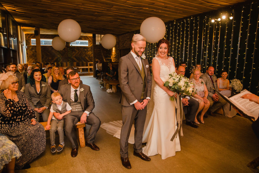 wide angle lens photograph of wedding service nuptials at Owen House Wedding Barn