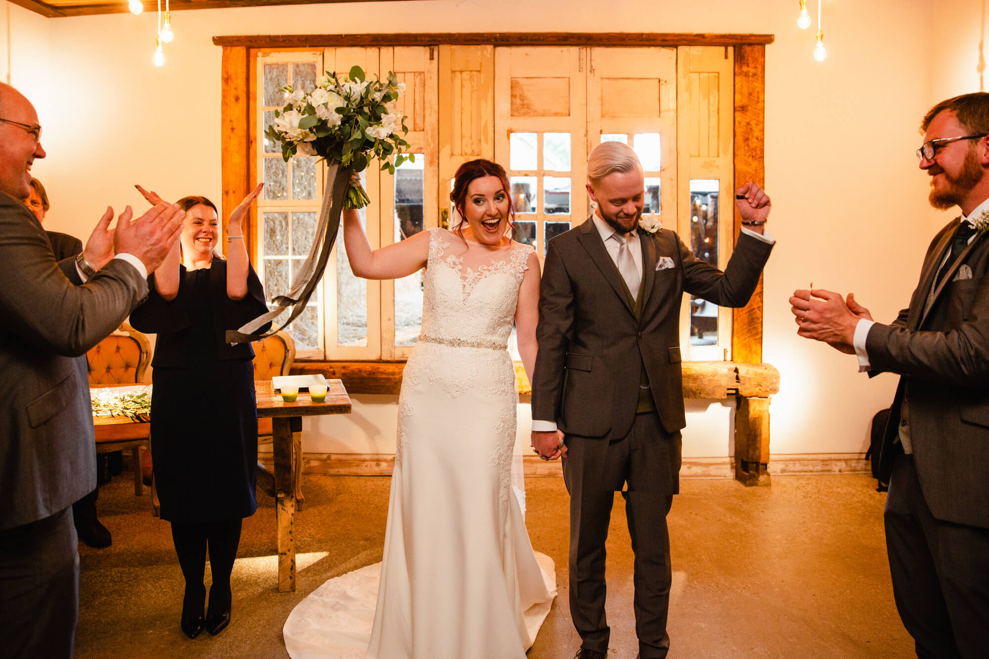 wedding processional begins at top of aisle as newly married couple celebrate with family and friends