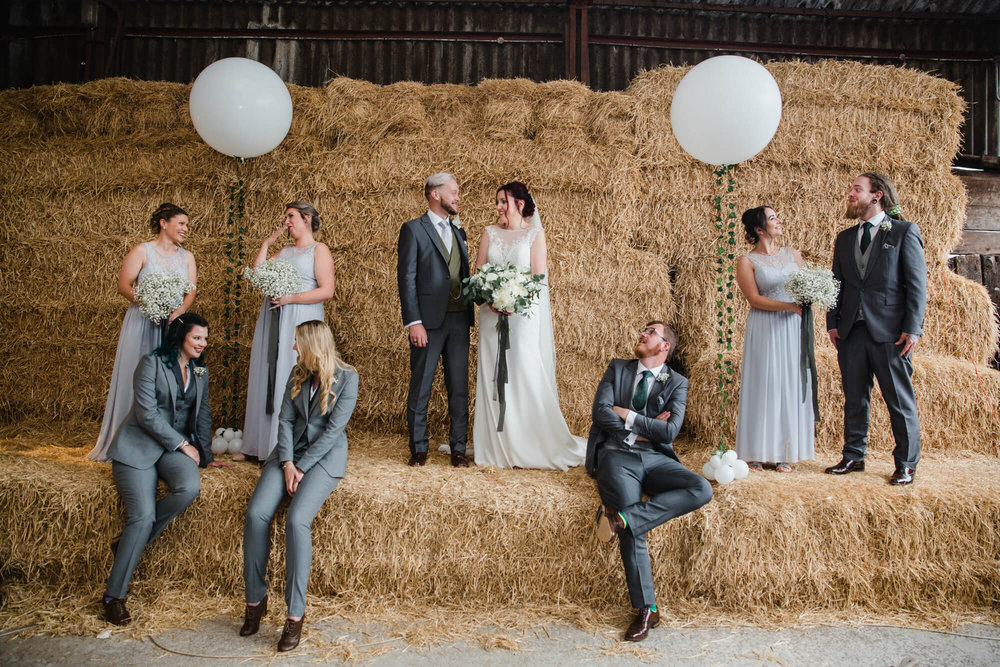 Owen House Wedding Barn photography group portrait on hay bale backdrop