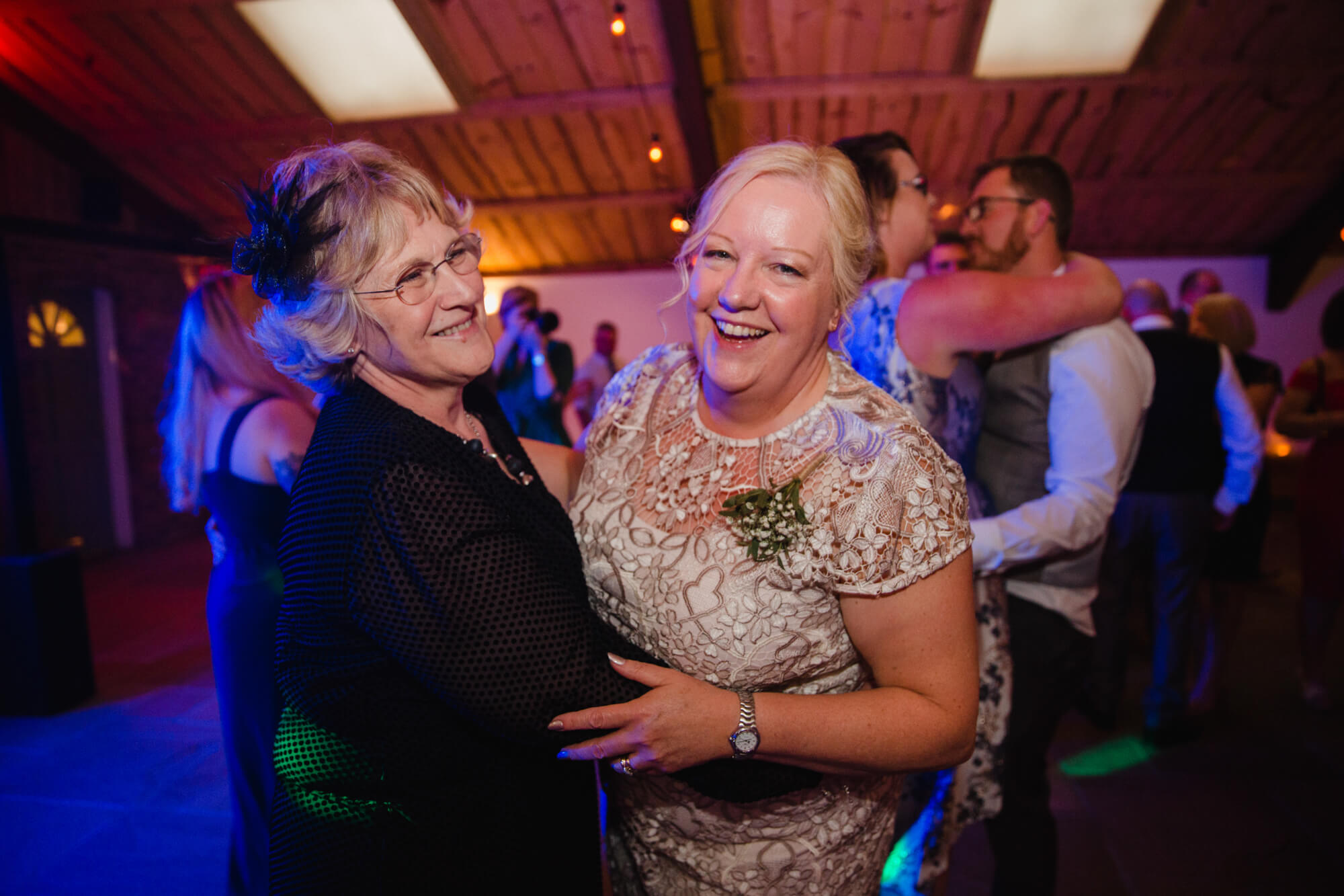 parents on dance floor dancing to music at end of wedding