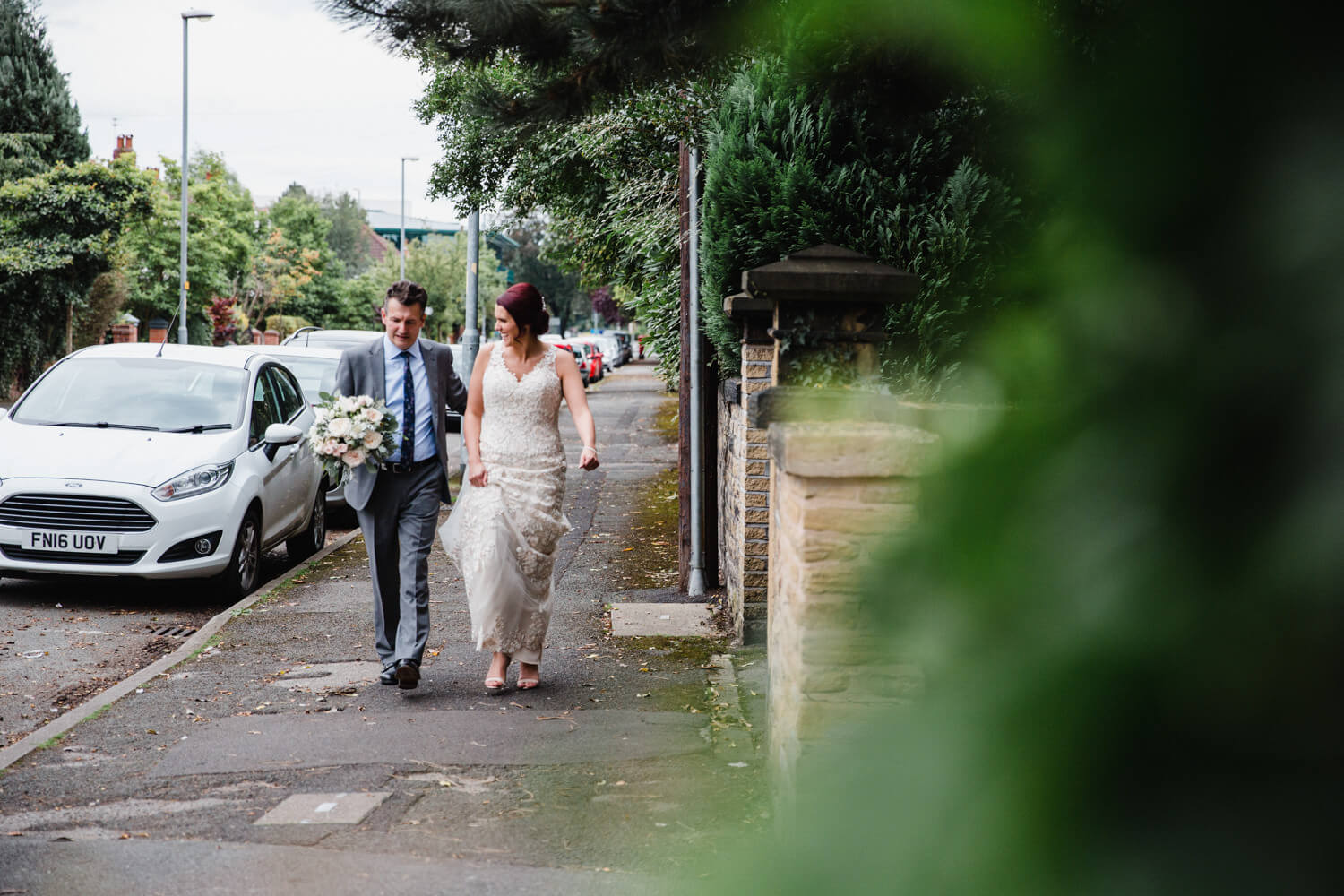 bride and father walking down Didsbury road to reception venue