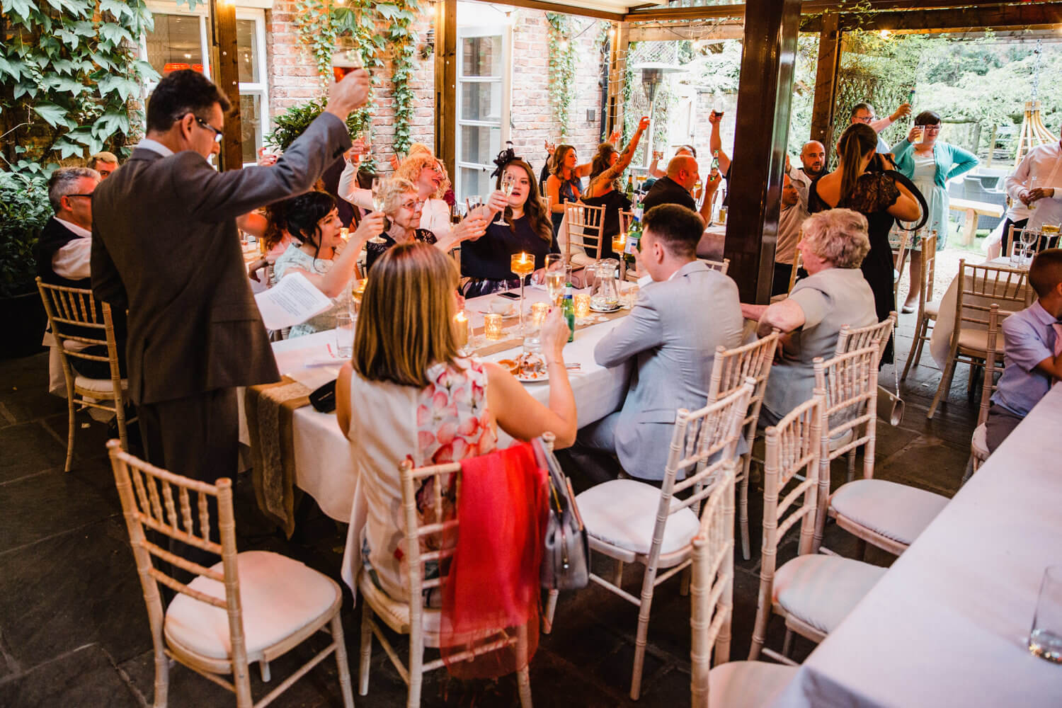 father of groom raises a toast to wedding party