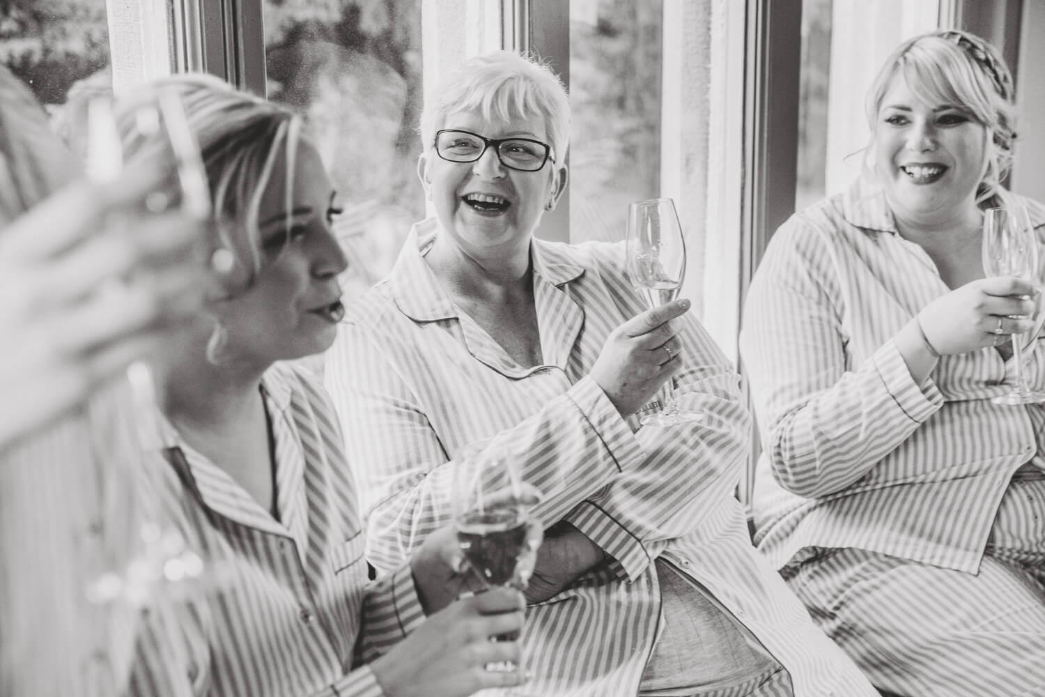 black and white photograph of mother receiving present from bride