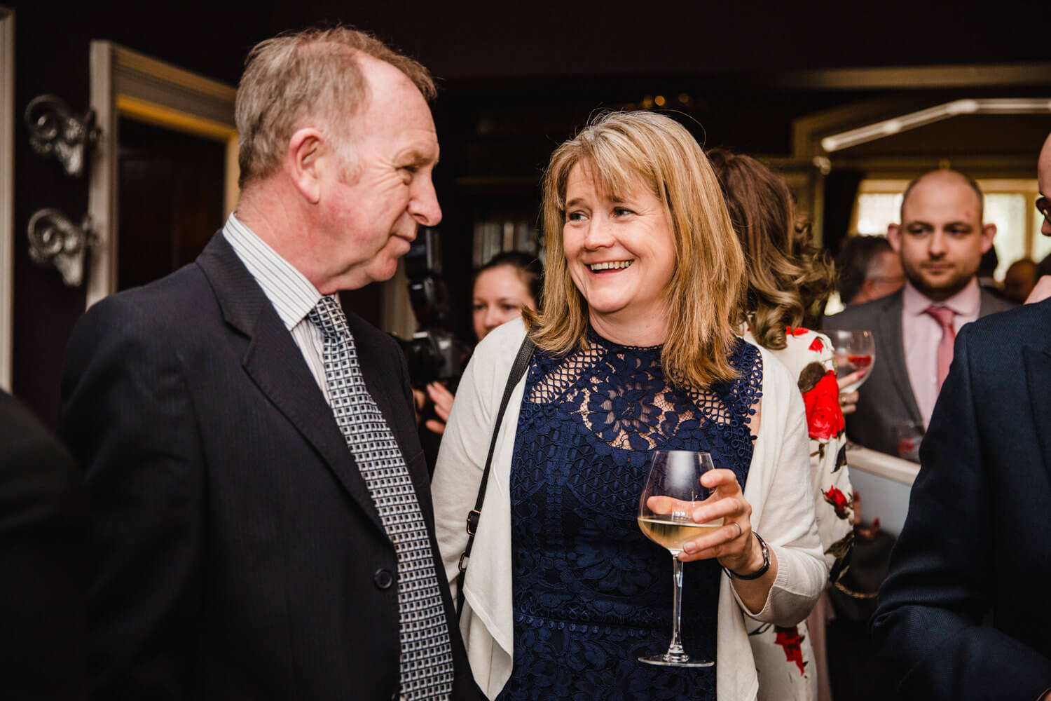 wedding guests having drinks before service begins