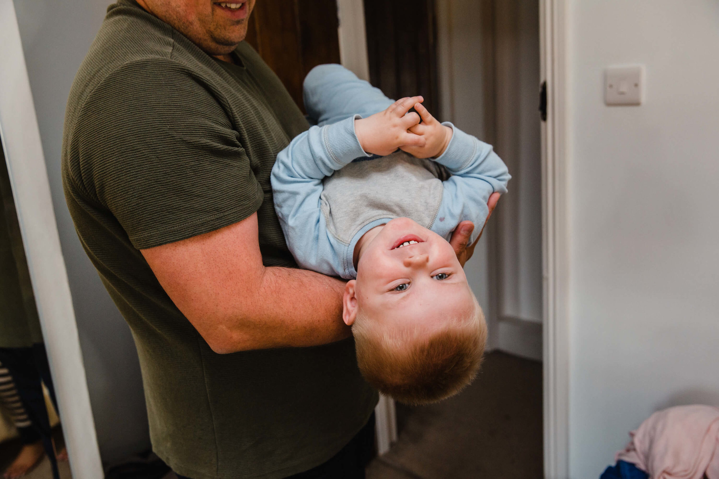 pageboy held upside down having fun