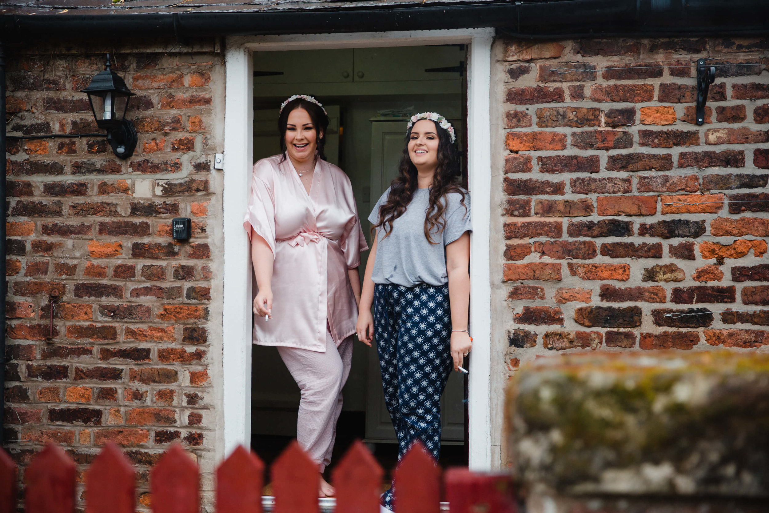 bridesmaids in doorway laughing and smiling