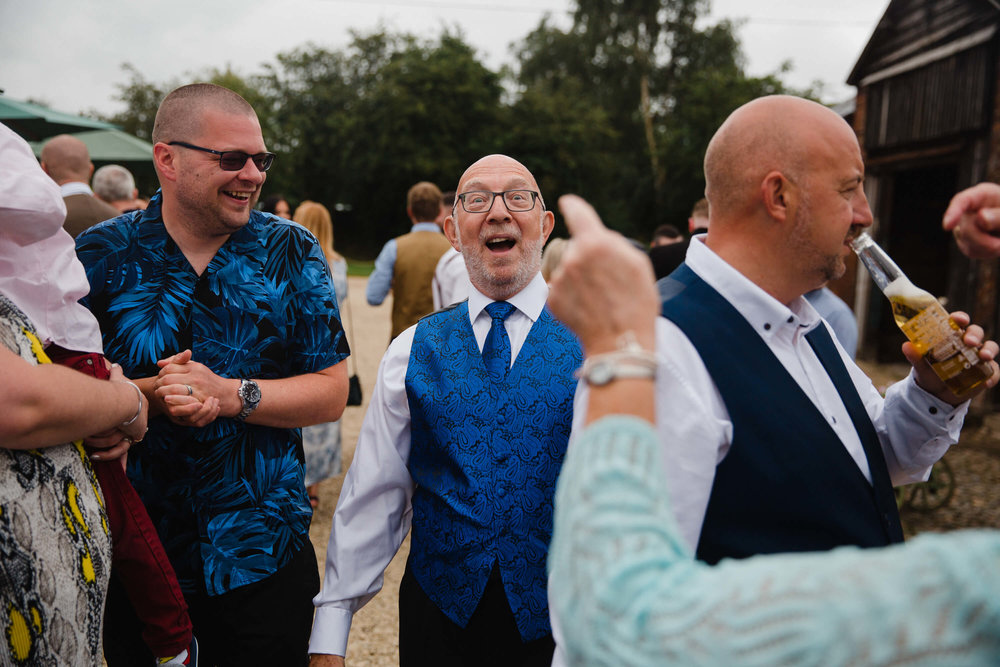natural relaxed funny moment as wedding guest is pointed at