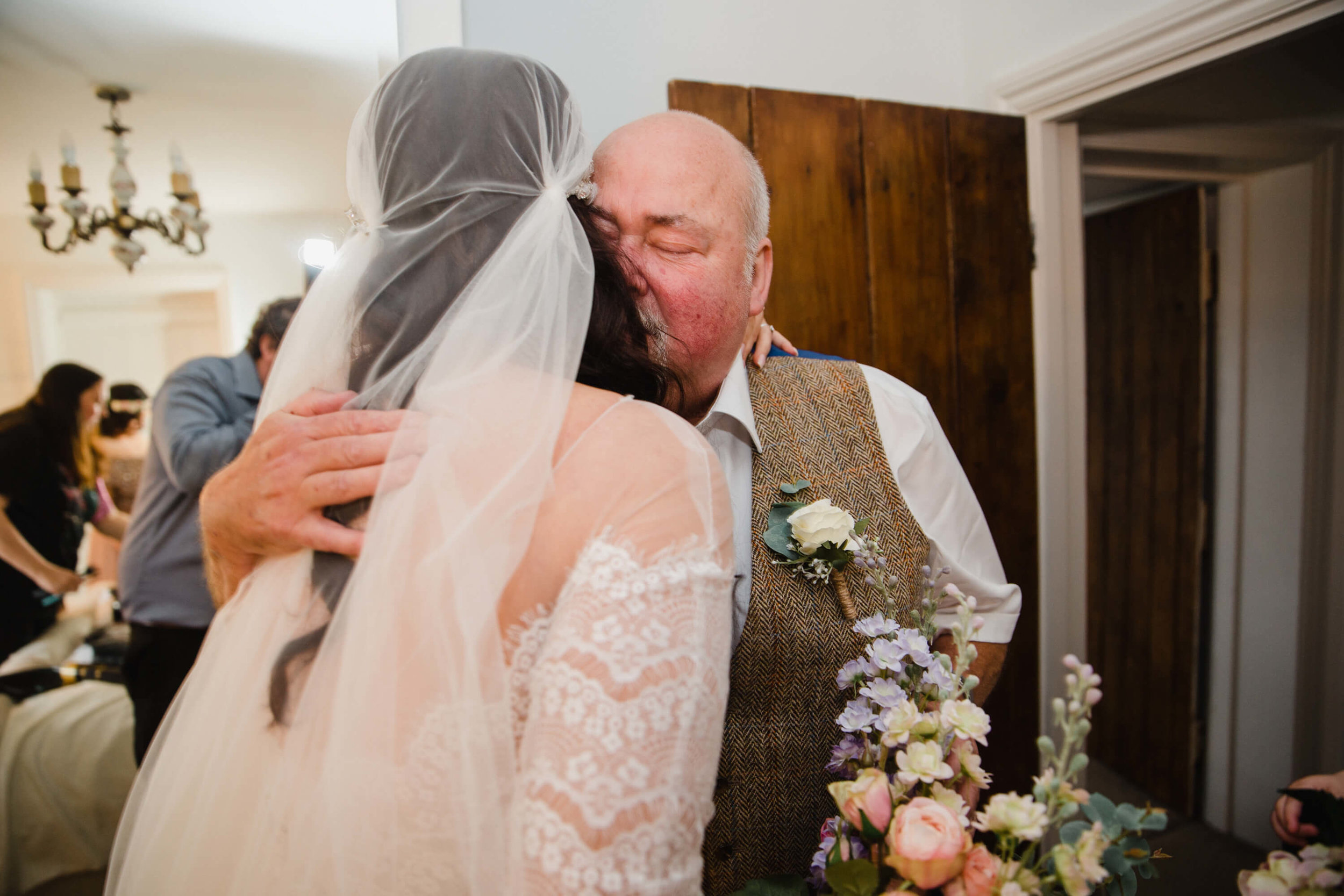 Father share hug with bride on stock farm estate