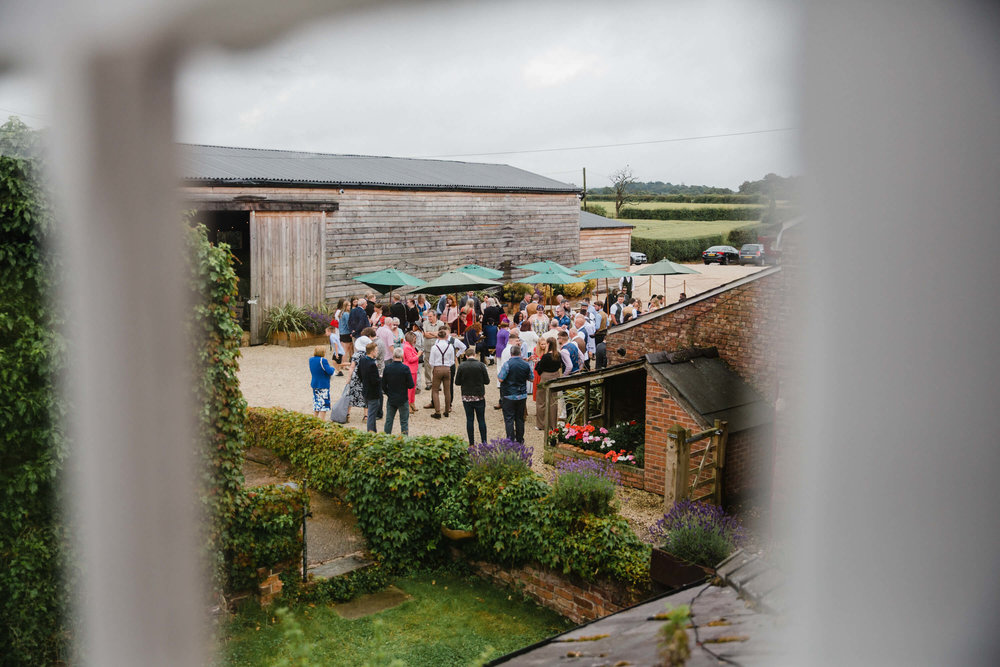 wide angle lens photograph of herd of wedding guests before ceremony