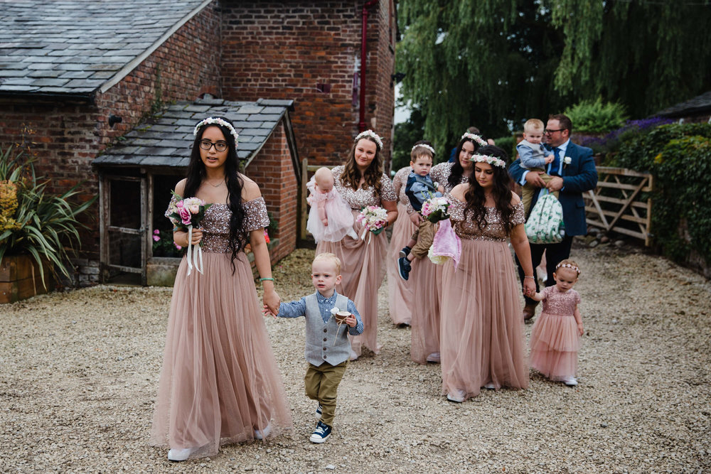 wedding procession of bridesmaids flock to service