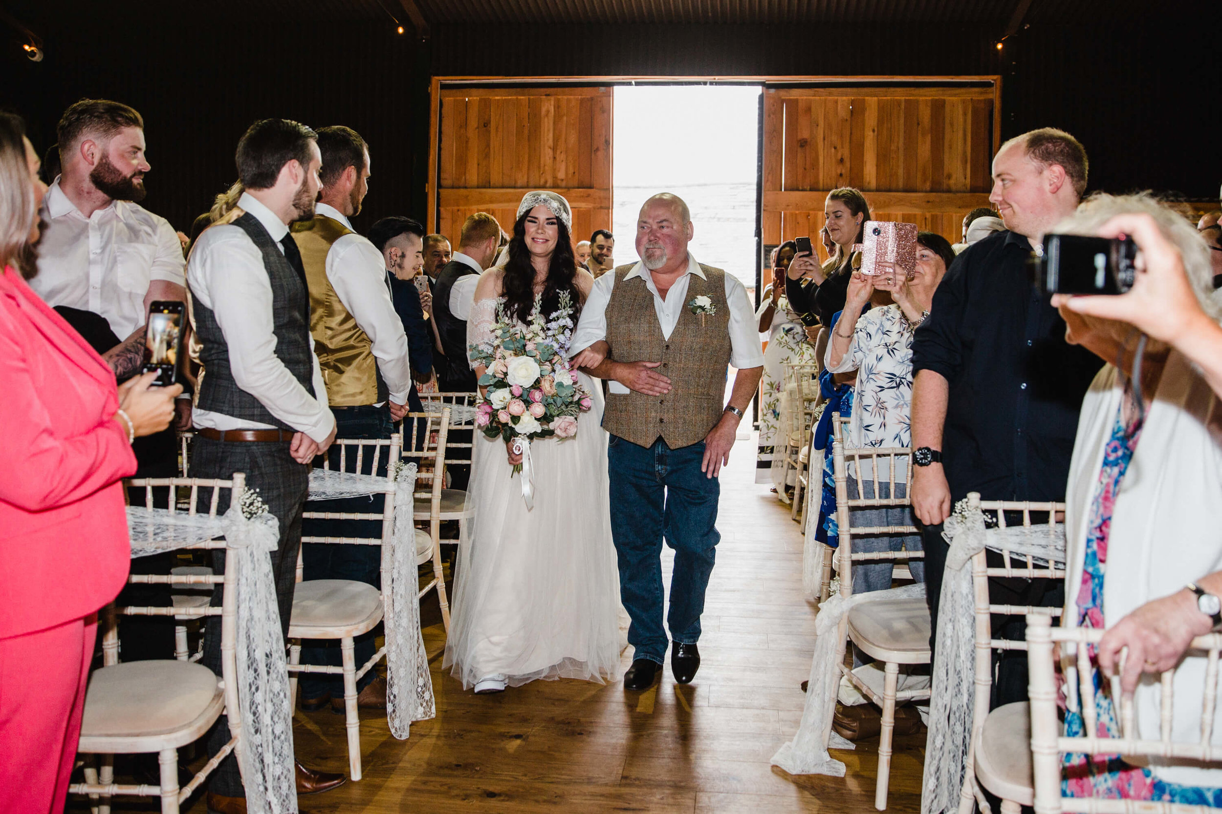 formal aisle walk entrance of the bride holding bouquet