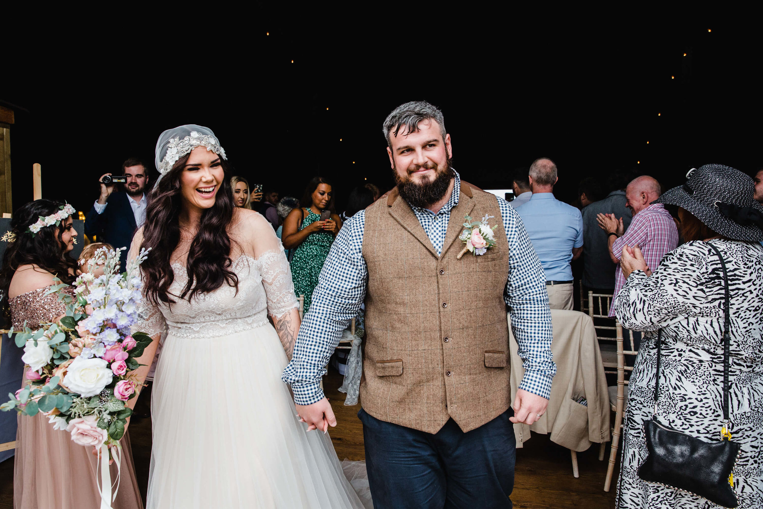 bride and groom hold hands after formal nuptial ceremony ends