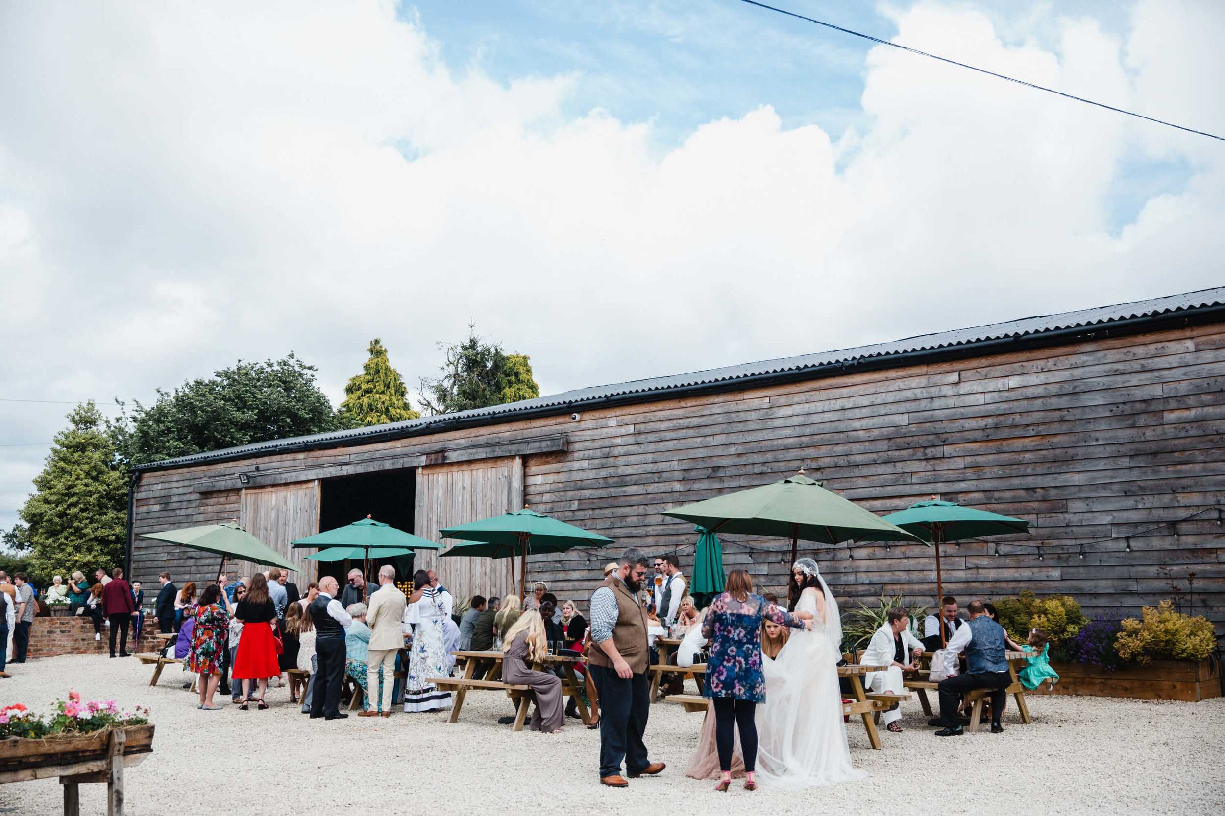 wedding party sat in outdoor ranch area next to ceremony room