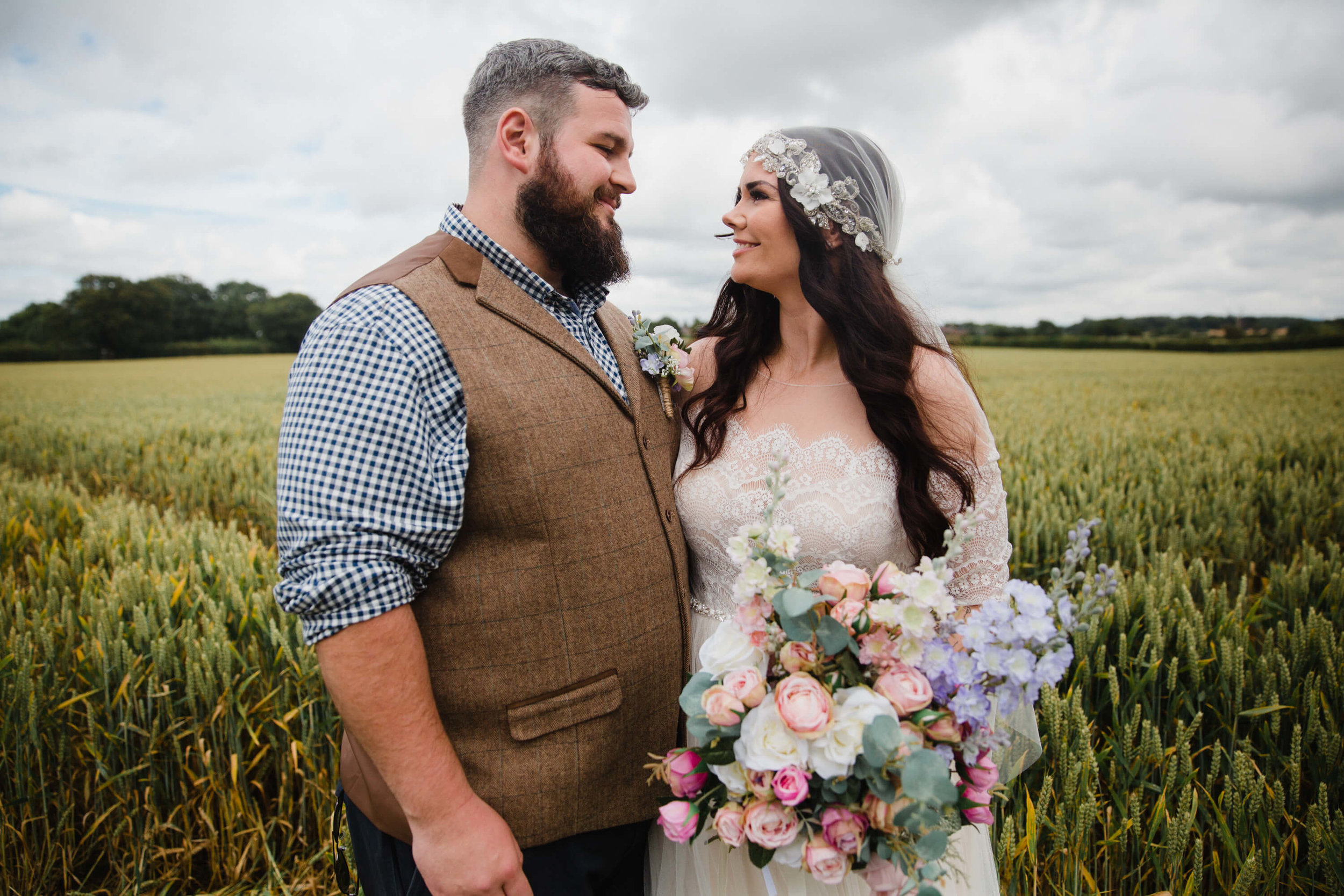 newlyweds sharing loving expression to one another in wheat fields