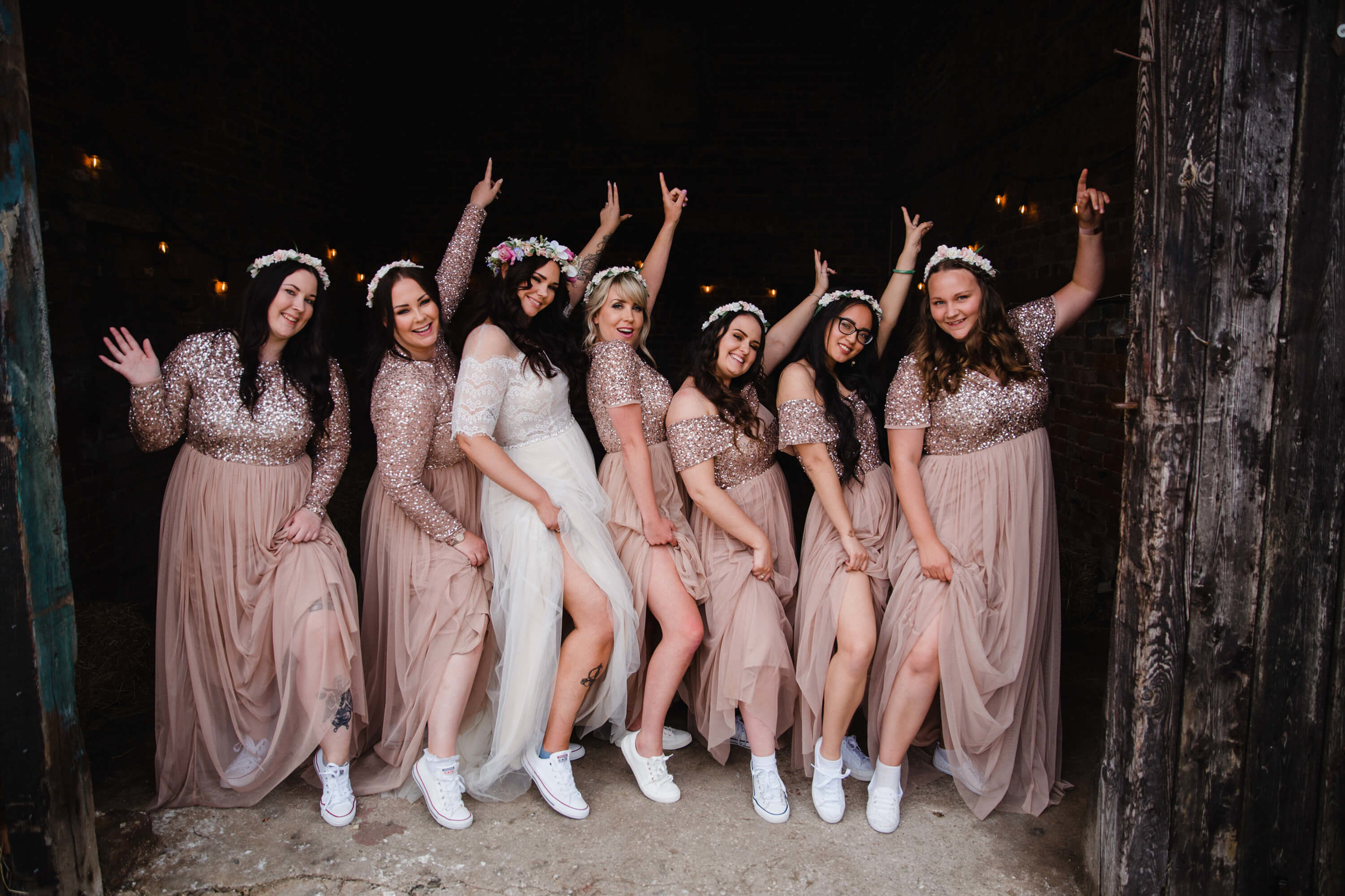 bridesmaids in entrance to ranch posing in floral head wreaths