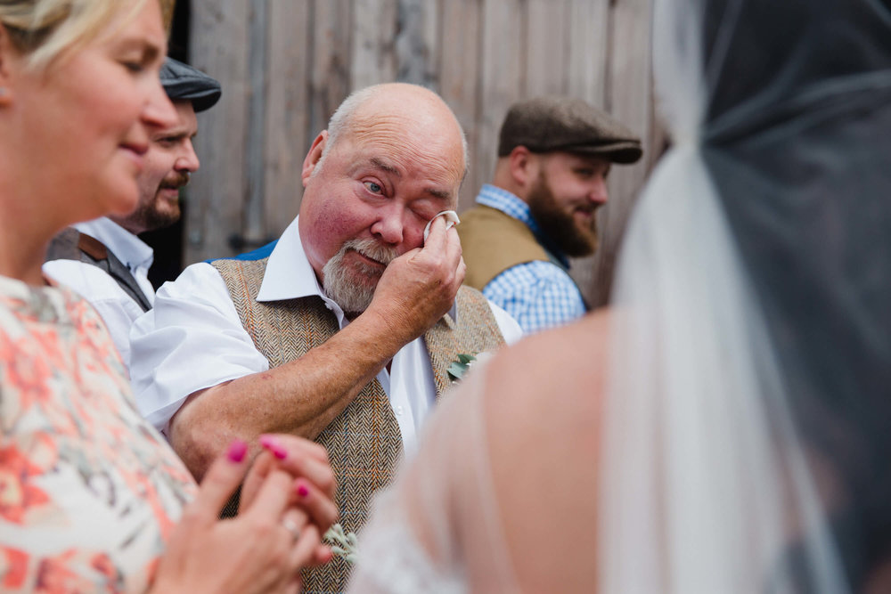 father of bride wipes away tear in natural moment caught on camera