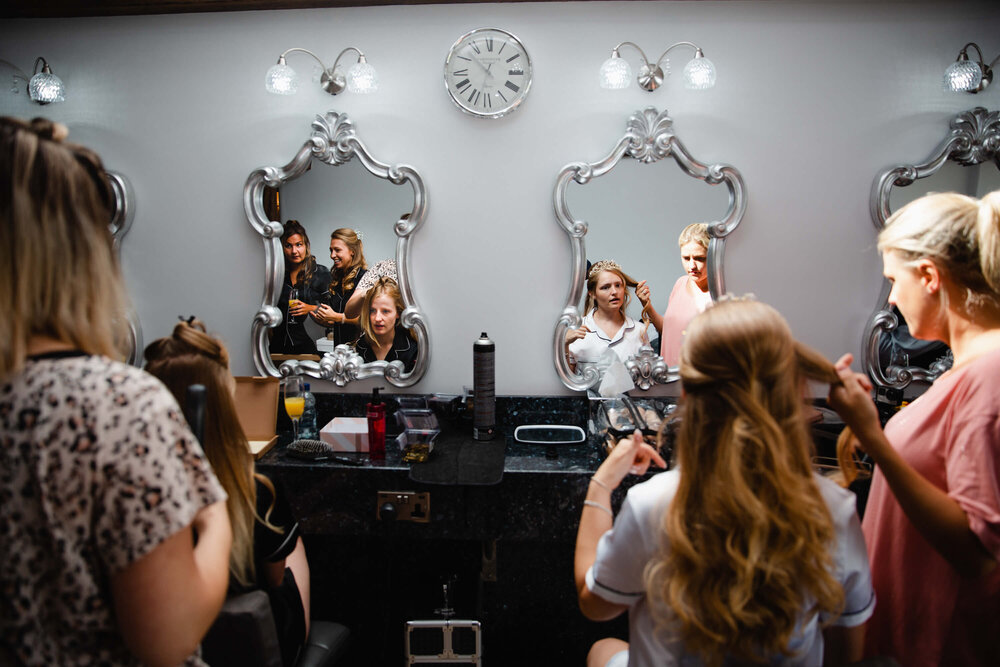 wide angle lens photograph of bridal party having make up applied in pamper room of heaton house farm