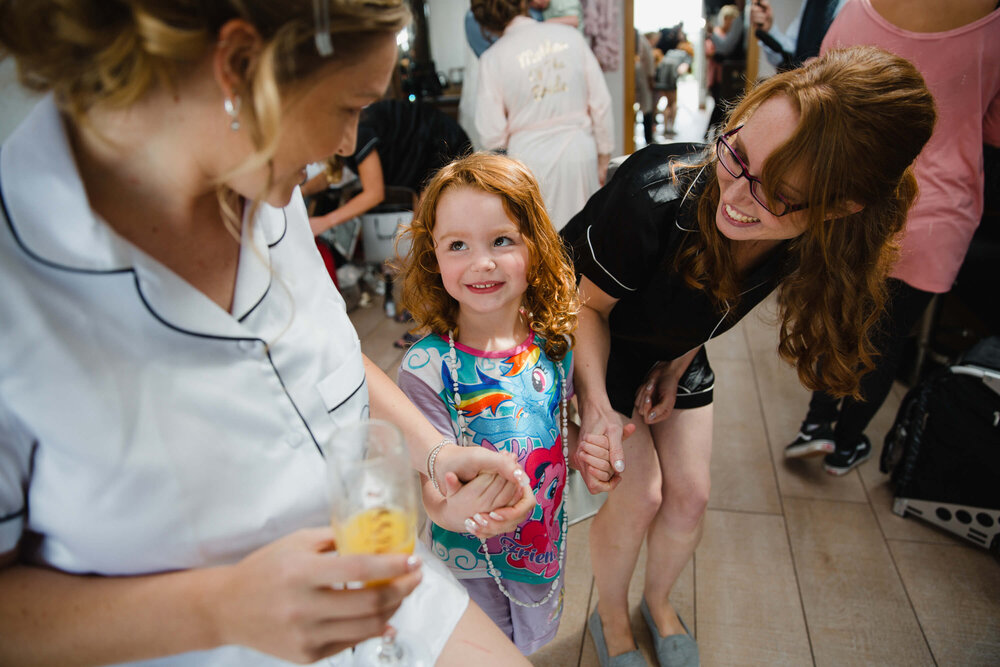 flower girl holding hands with bride