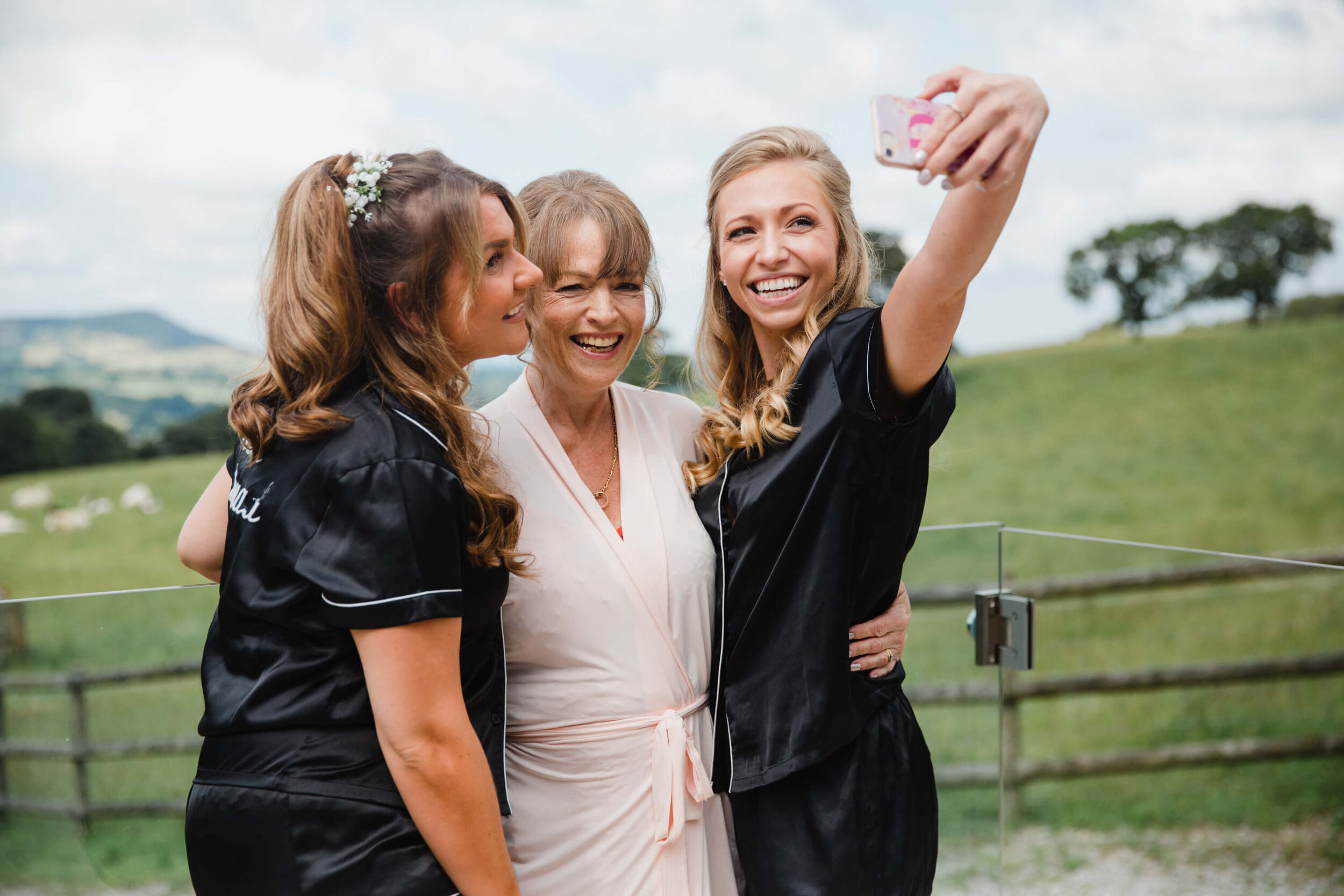 bridesmaids taking selfie using camera phone