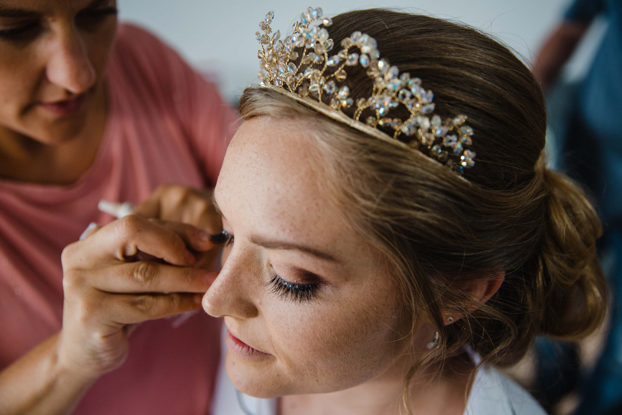 close up photograph of bride having mascara applied to lashes
