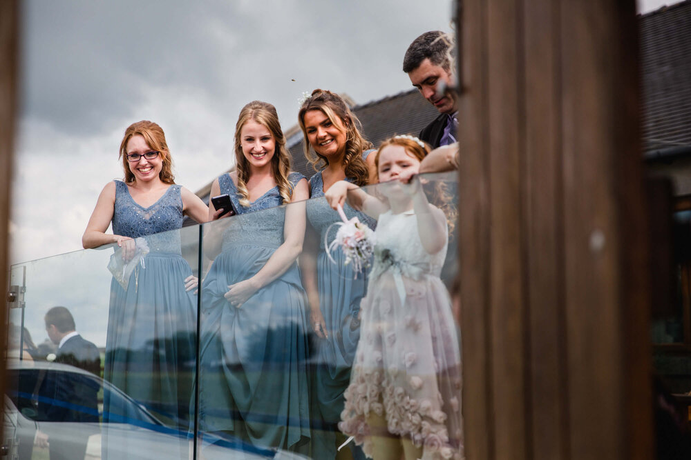 bridal party watching on at exchange of wedding cards