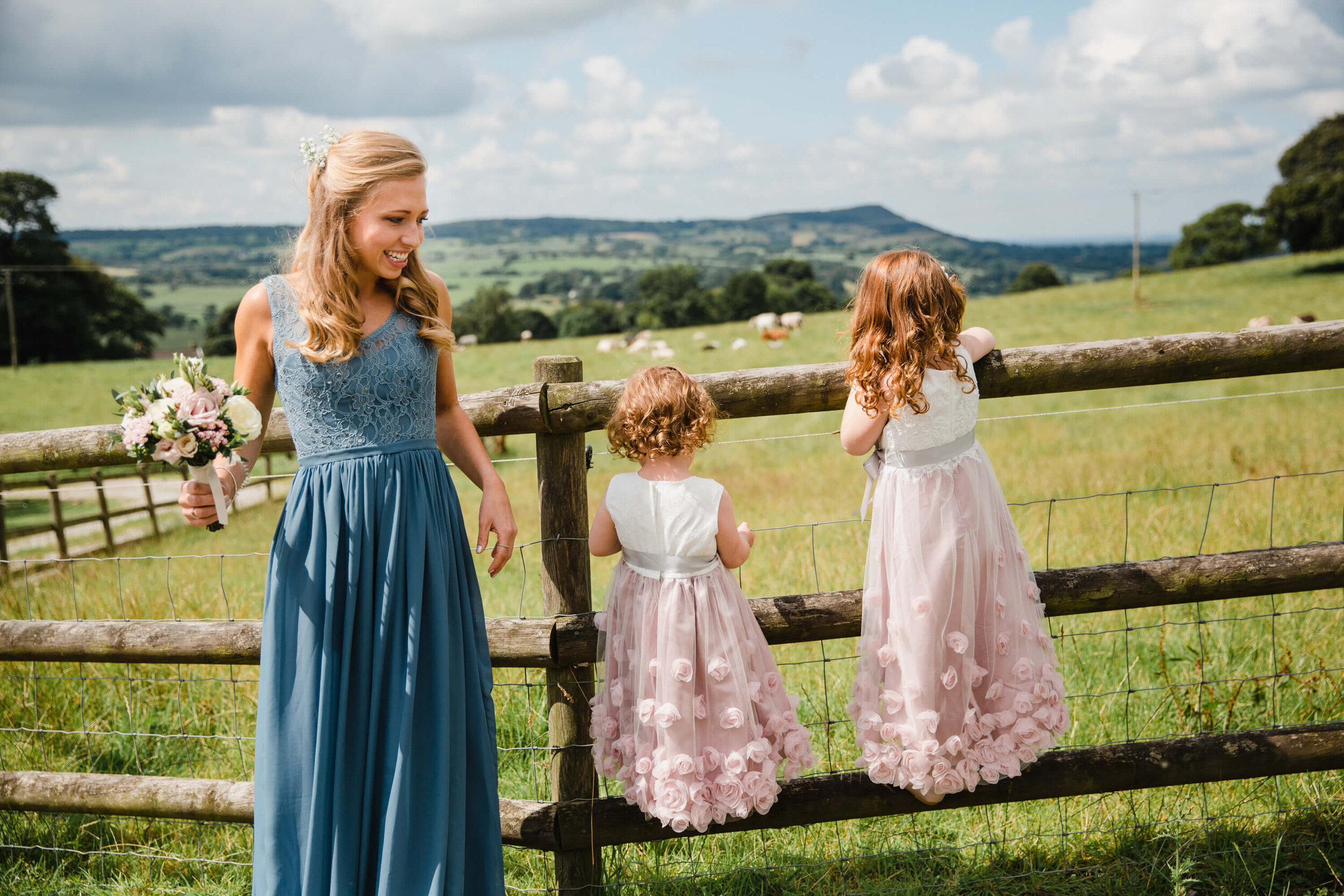 flower girls looking out on colourful meadows