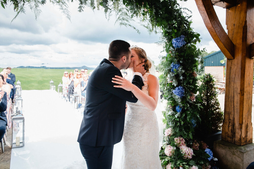 close up first kiss of newly married couple