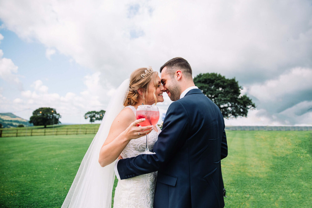 newlyweds share charming moment together with grassland acreage backdrop 