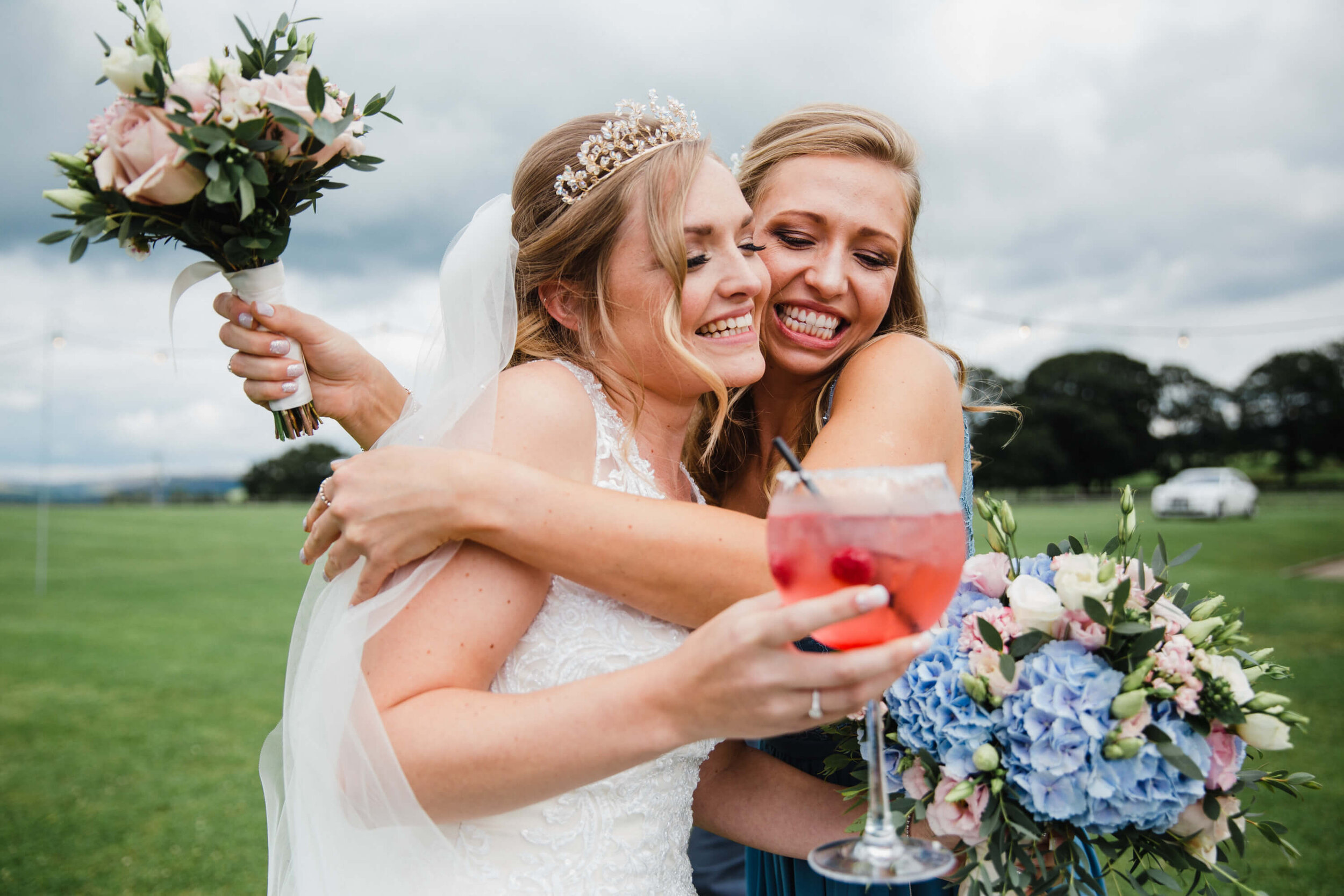 bridesmaid sharing hug with bride
