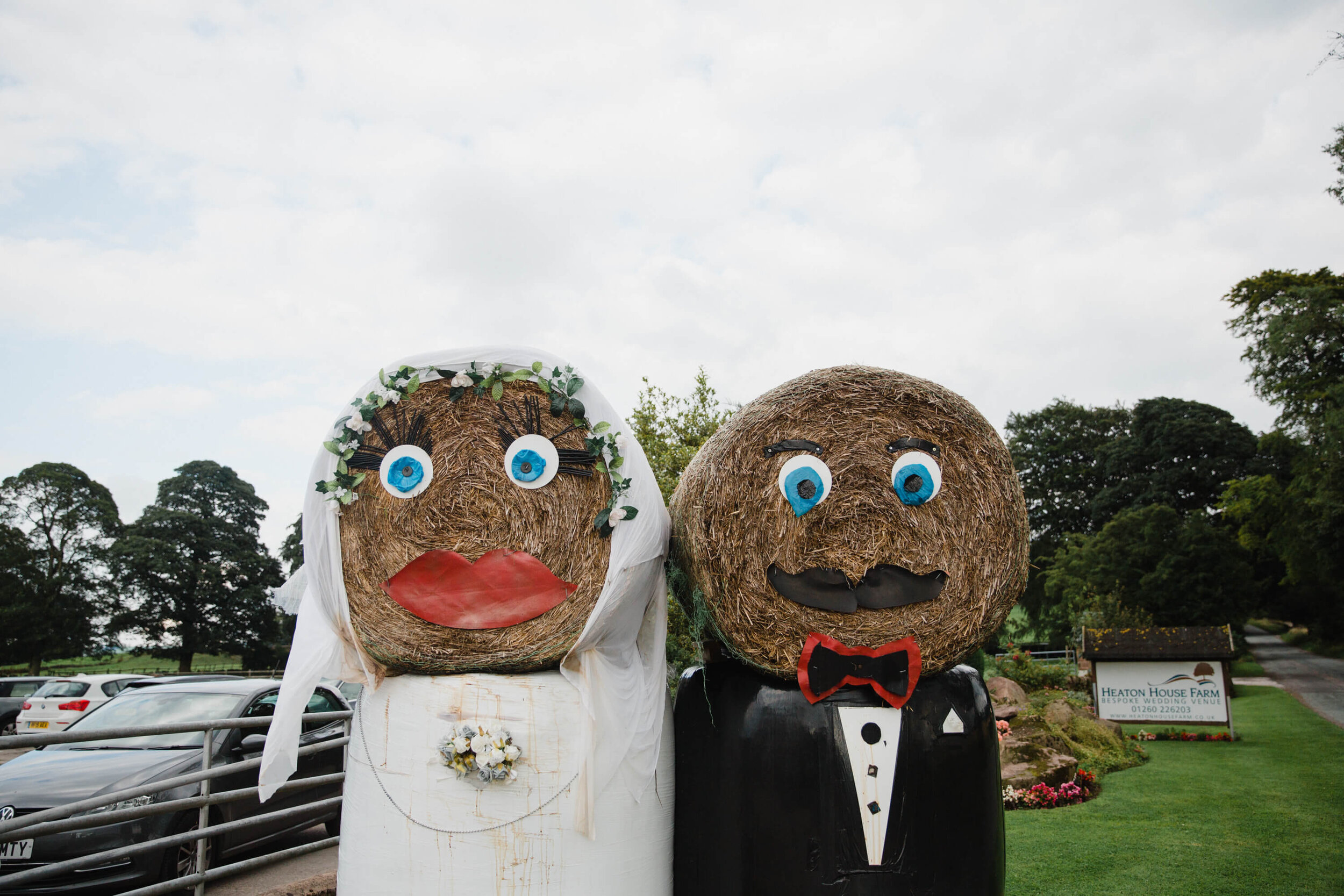 bride and groom hay bales outside wedding venue