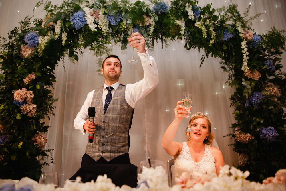 groom raises a toast to wedding party
