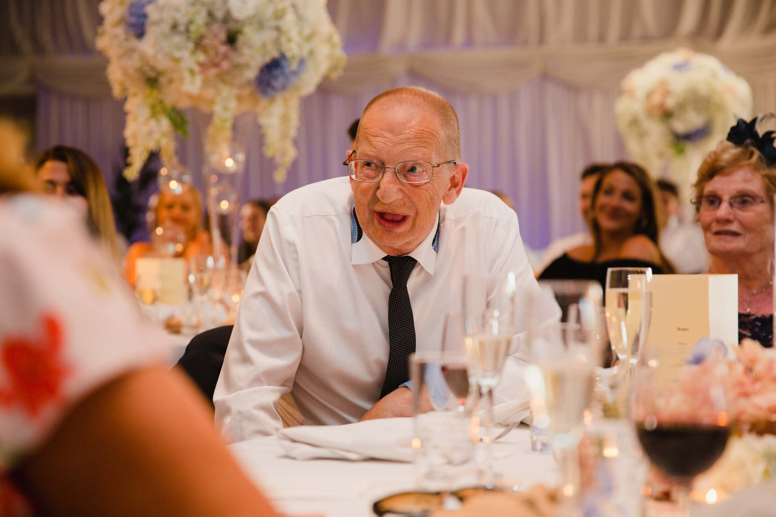 close up photograph of grandad laughing at speeches