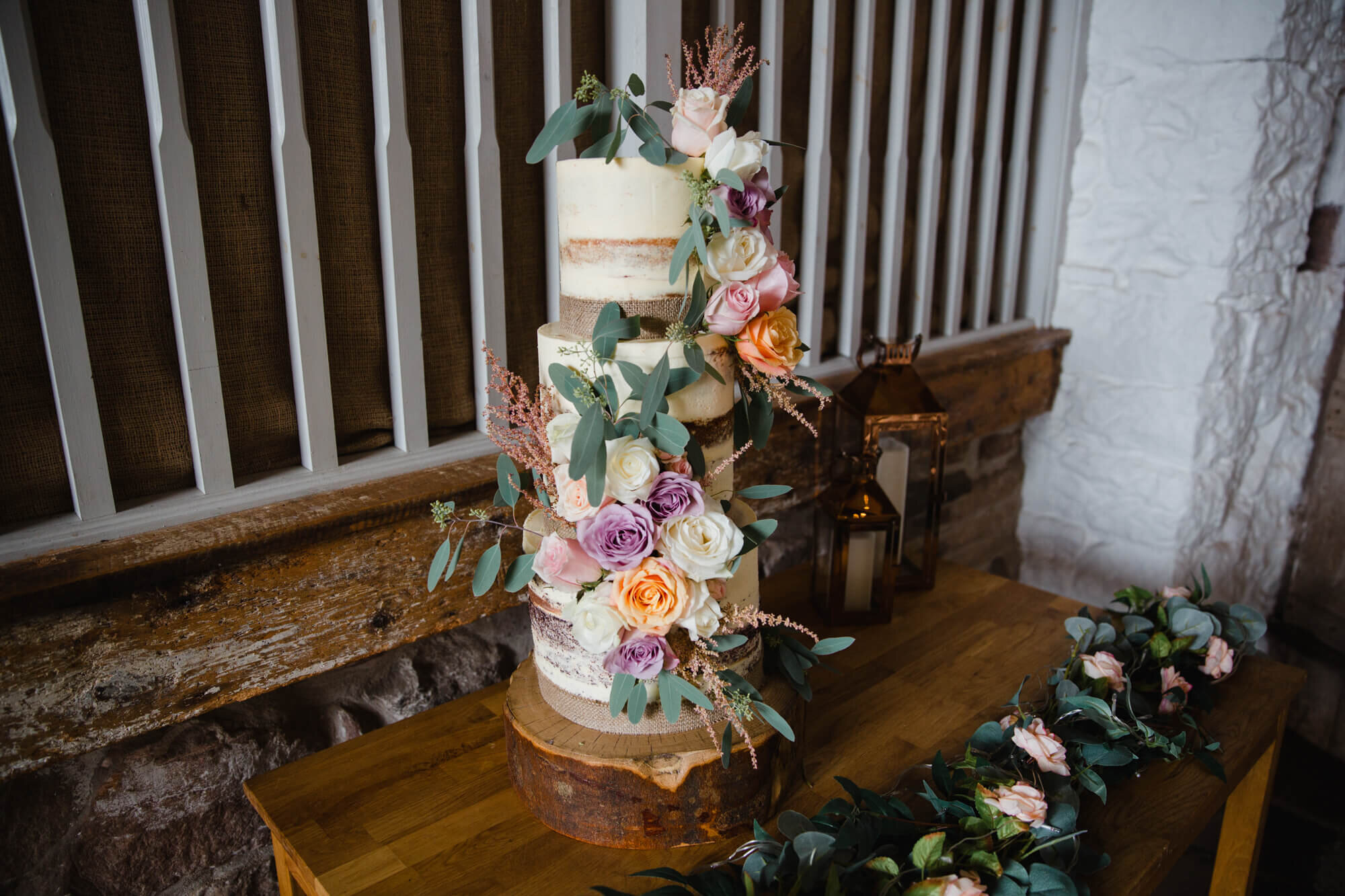 wedding cake dressed with flowers on table