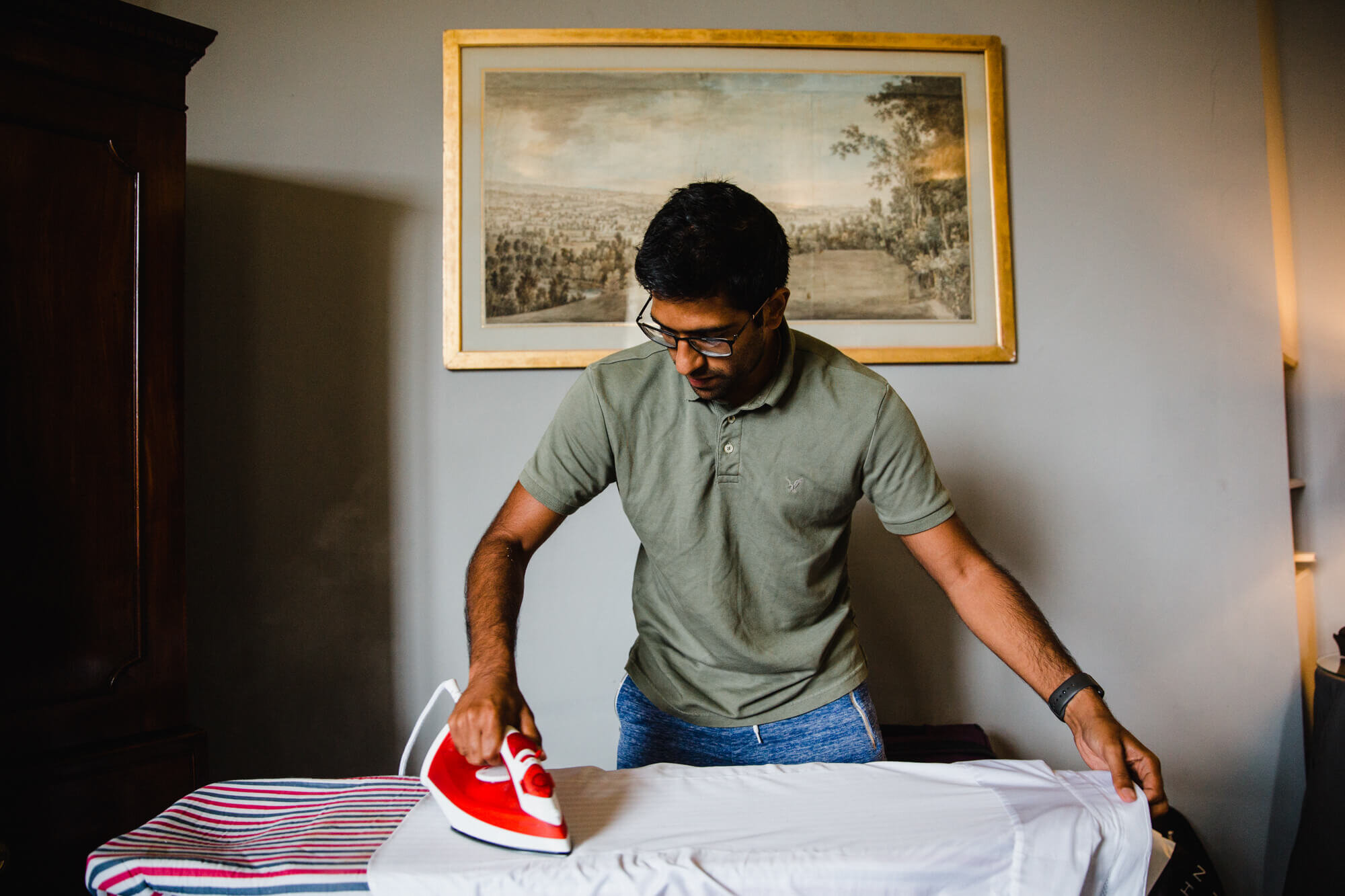 groomsman ironing shirt