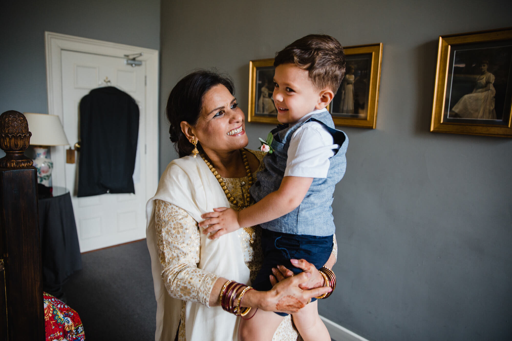 mother of bride holding pageboy in bridal suite
