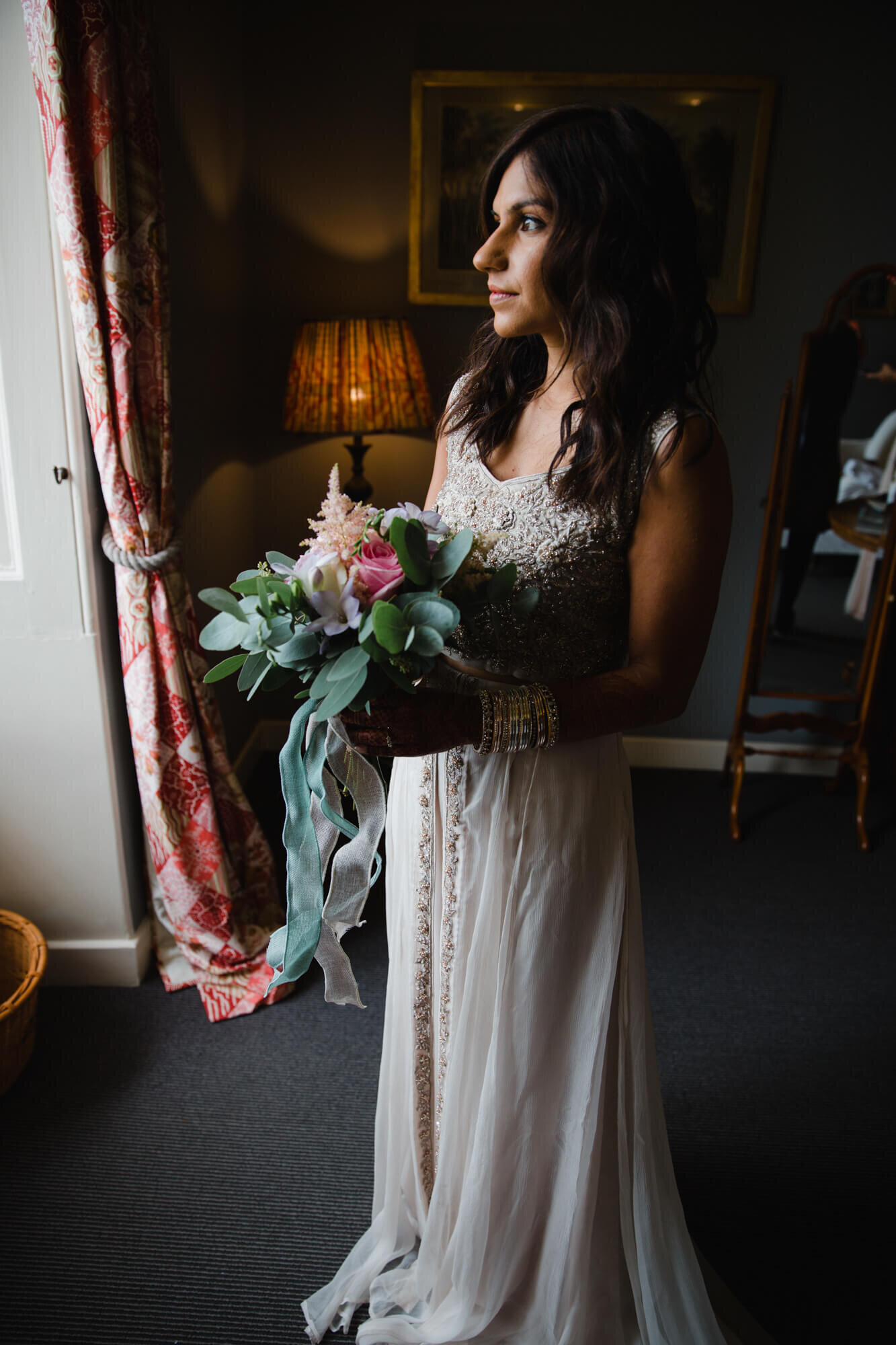 bride holding floral bouquet for posed portrait 