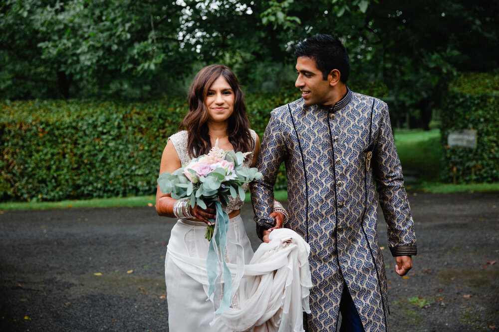 groomsman looks at bride on way to ceremony