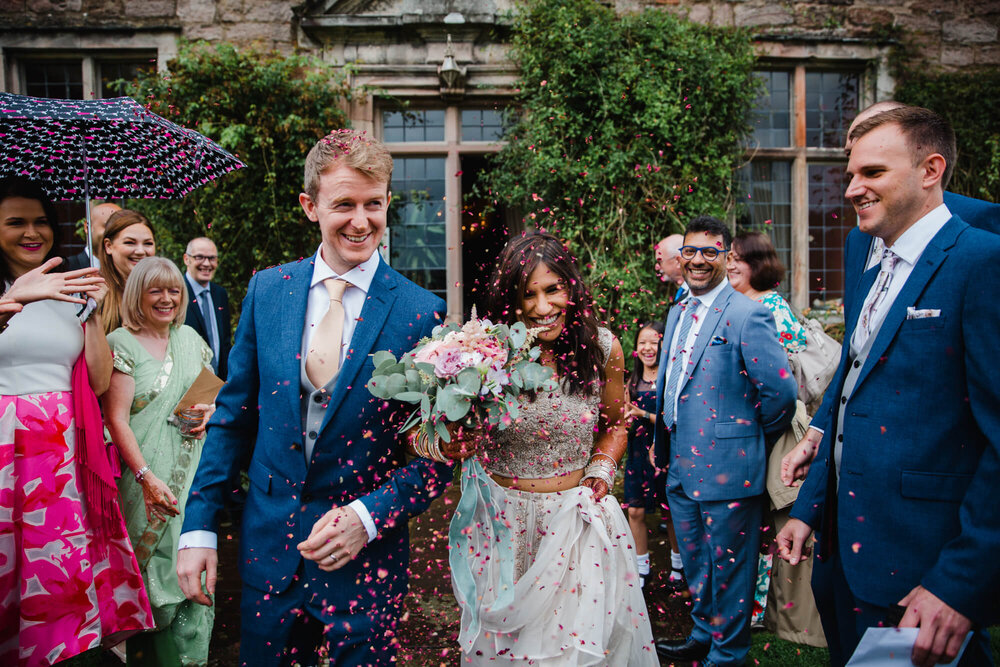 guests with ready made confetti kits thrown petal tips over newlyweds