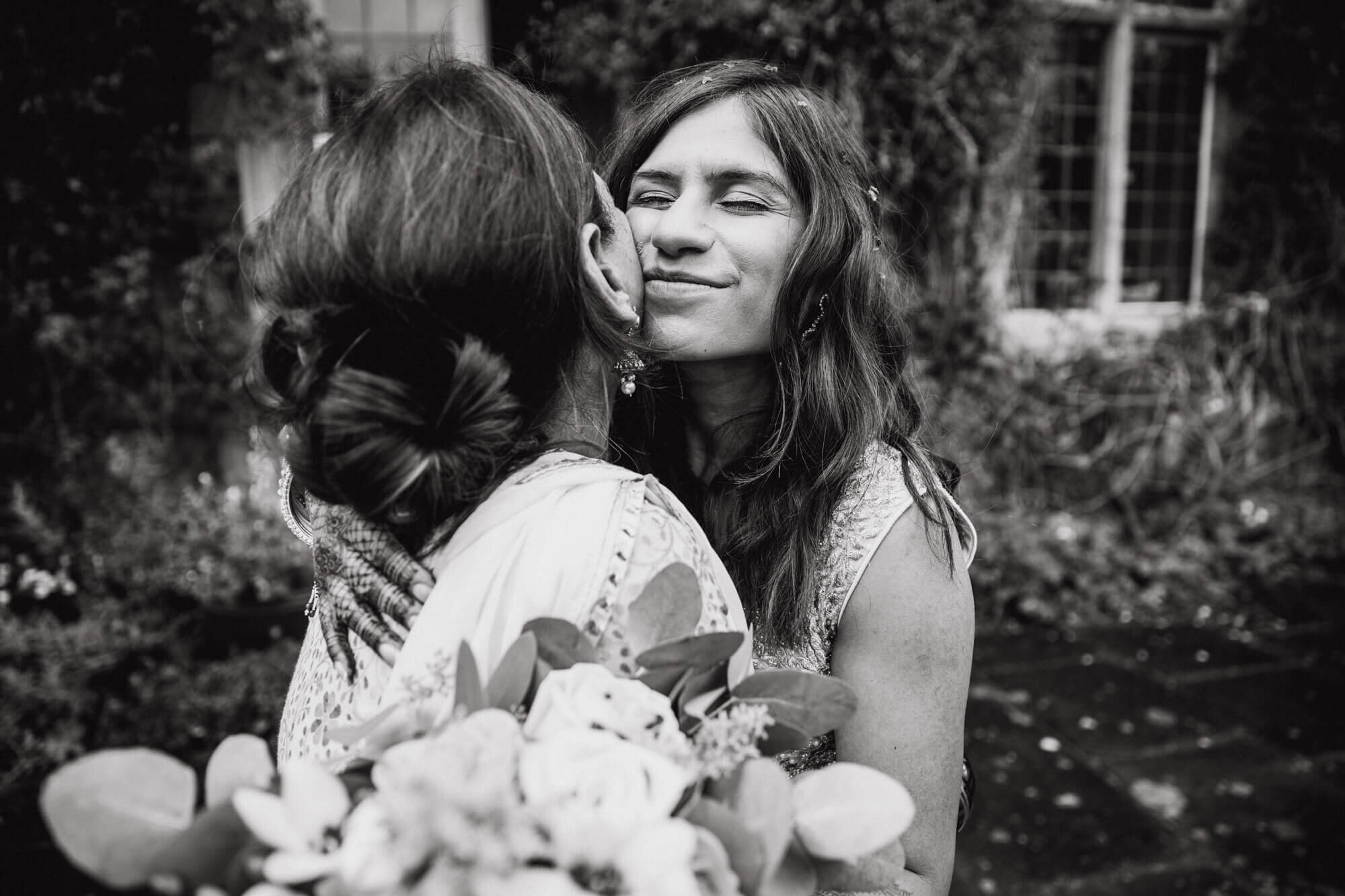 monochrome photograph of intimate moment between bride and sister