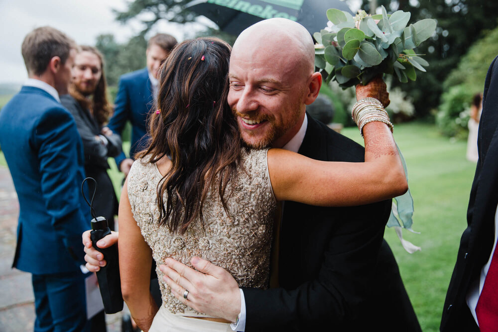 wedding guest shares hug with bride