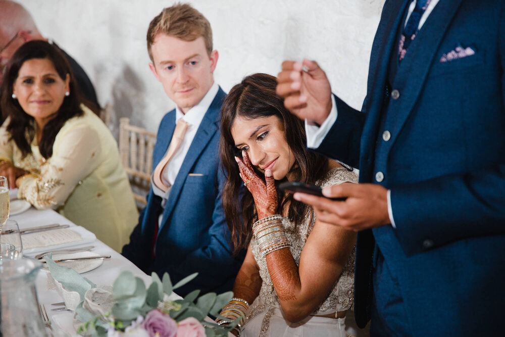 bride wipes away tear during speeches at askham hall