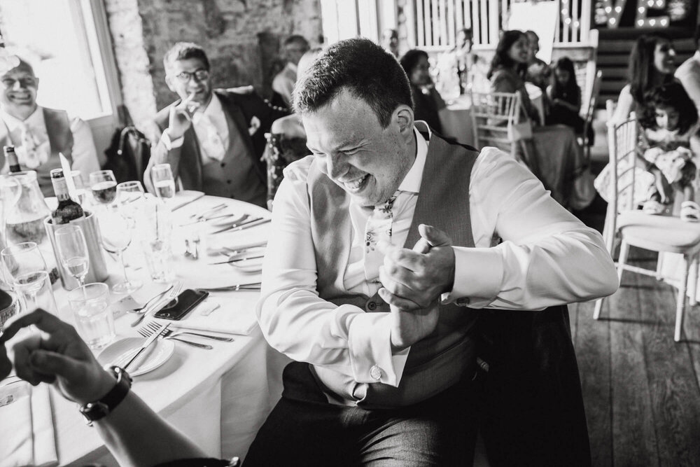 black and white photograph of guest laughing at speeches