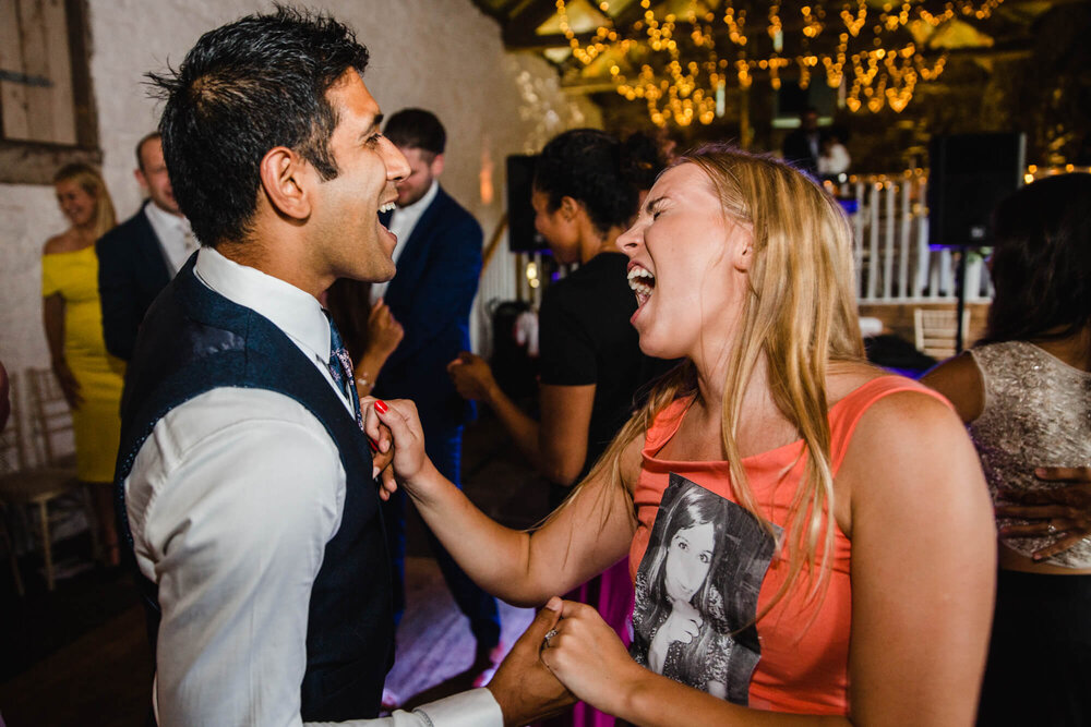 bridesmaids and groomsmen dancing to music at Askham Hall